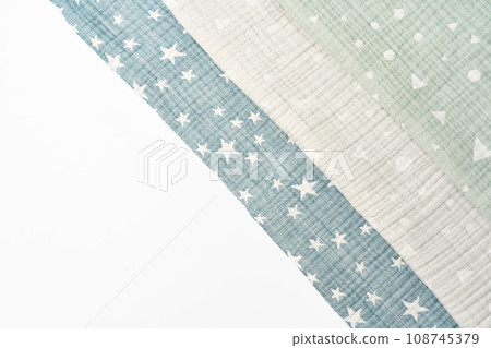 Three folded cotton blankets on white background Three folded cotton blankets on white background 108745379