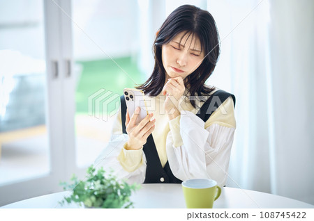 Woman operating a smartphone 108745422
