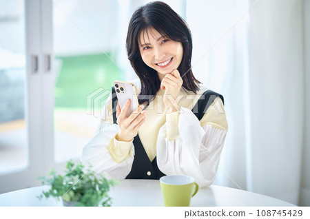 Woman operating a smartphone 108745429