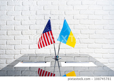 USA and Ukraine flags on negotiation table 108745781