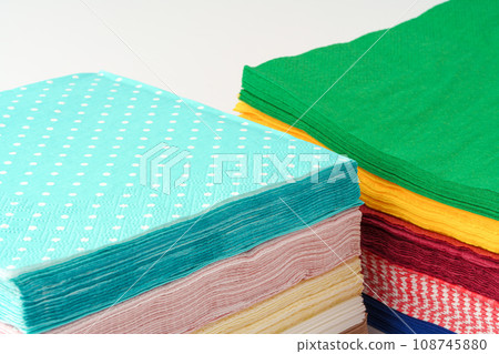 Two stacks of colorful paper napkins on white background 108745880