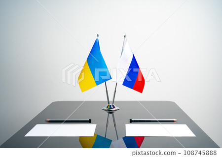 Russia and Ukraine flags on negotiation table 108745888
