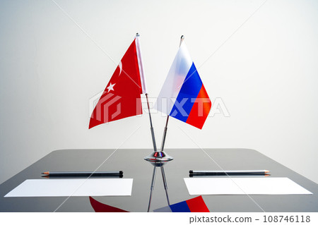 Flags of Turkey and Russia on poles on negotiation table 108746118
