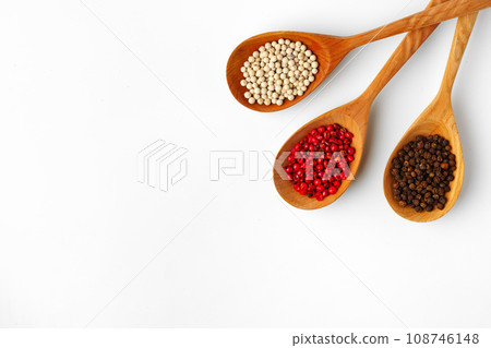 Wooden spoons with various spices isolated on white background Wooden spoons with various spices isolated on white background 108746148