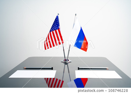 Flags of Usa and Russia on negotiation table Flags of Usa and Russia on negotiation table 108746228