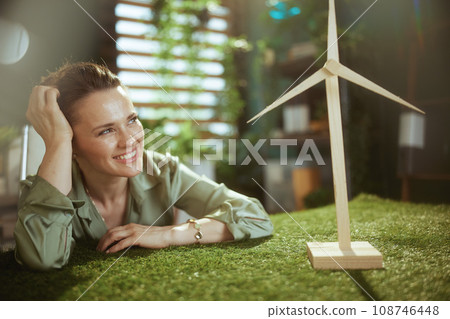 smiling business owner woman in green blouse in green office 108746448
