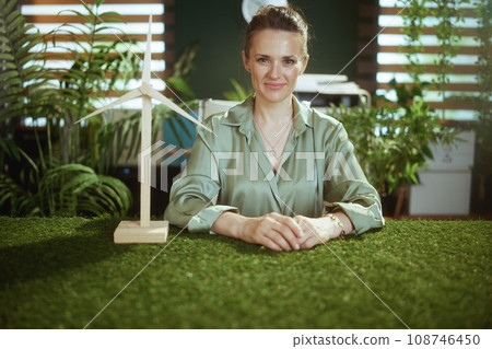 business woman in green blouse in modern green office 108746450