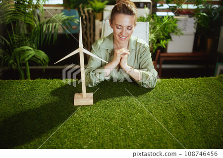 happy elegant business owner woman in green office 108746456