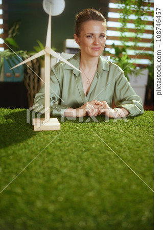 40 years old business woman in green blouse in green office 40 years old business woman in green blouse in green office 108746457