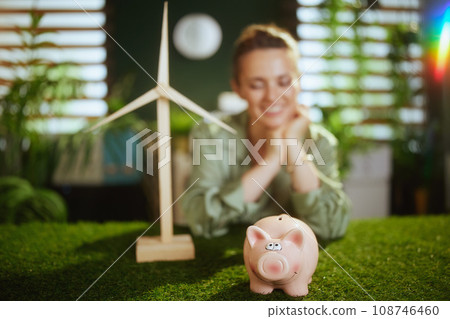 Smiling business woman in green blouse in green office 108746460