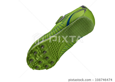 Green sole with spiked sneakers on a white background. Sport shoes. 108746474