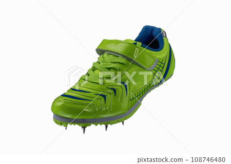 Green glossy sneaker with spikes on a white background. Sport shoes. Green glossy sneaker with spikes on a white background. Sport shoes. 108746480