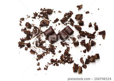 Chocolate crumbs with slices. Crushed chocolate on a white background 108746524