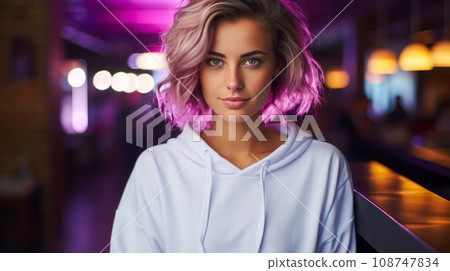 Portrait of a beautiful young blonde woman dressed casually, neon lighting on the evening street 108747834