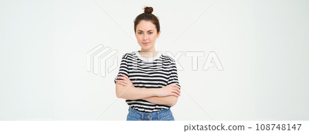 Portrait of young stylish woman, 25 years old, looking upbeat and motivated, posing for photo against white background Portrait of young stylish woman, 25 years old, looking upbeat and motivated, posing for photo against white background 108748147