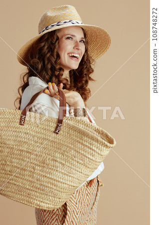 happy housewife in blouse and shorts isolated on beige 108748272