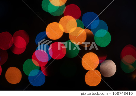 Colorful sparkling and defocused lights on dark background. Christmas theme. Abstract bokeh wallpaper. 108748410