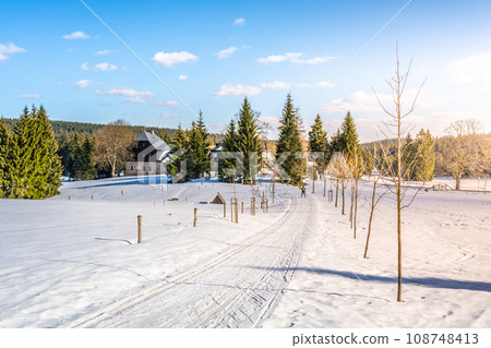 Cross country skiing track on sunny winter day. Samals Hut, Czech: Samalova chata, at Nova Louka. Jizera Mountains, Czech Republic 108748413