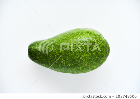 Ripe juicy avocado fruit on a white background. Vegetarian vegetables. Green fruits. Ripe juicy avocado fruit on a white background. Vegetarian vegetables. Green fruits. 108748506