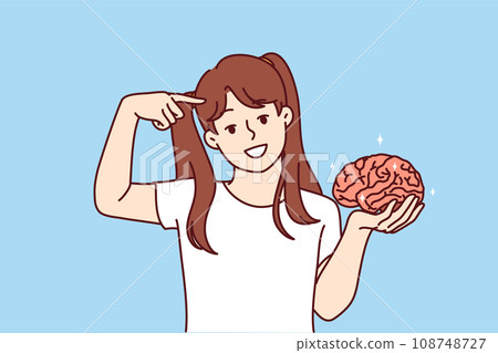 Little girl holds brain in hand and points finger at head, calling take care of increasing iq 108748727