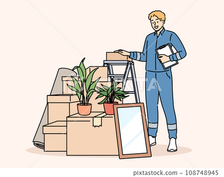Man mover stands near pile of cardboard boxes advertising services of company that helps with moving Man mover stands near pile of cardboard boxes advertising services of company that helps with moving 108748945