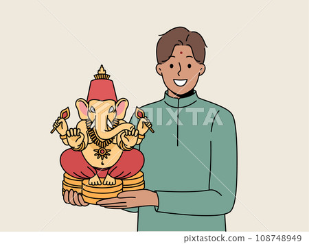Indian man holds figurine Lord ganesha and smiles demonstrating amulet that brings good luck 108748949