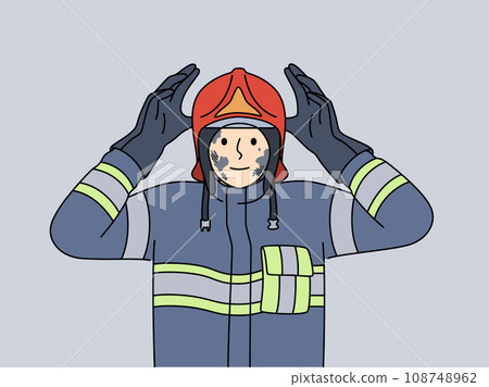 Man firefighter in uniform with traces of soot on face after extinguishing burning building 108748962
