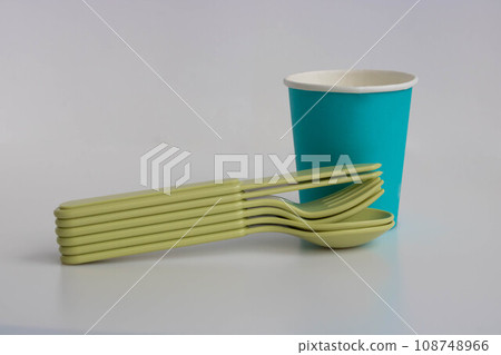 Disposable blue paper cup and disposable plastic cutlery in olive color Disposable blue paper cup and disposable plastic cutlery in olive color 108748966