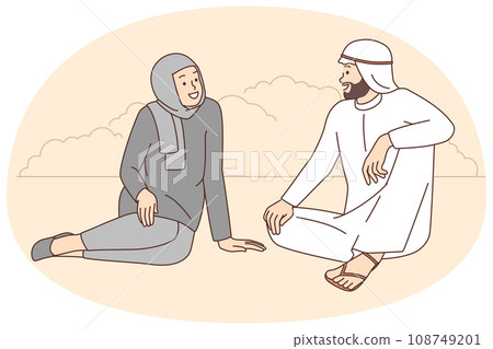 Happy Arabic couple talking outdoors 108749201
