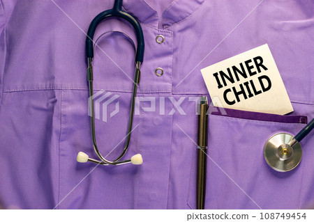 Inner child symbol. Concept words Inner child on beautiful white card. Beautiful purple background. Stethoscope on medical uniform. Psychological, motivational inner child concept. Copy space. 108749454
