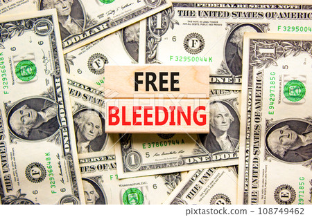 Free bleeding symbol. Concept words Free bleeding on beautiful wooden block. Beautiful background from dollar bills. Dollar bills. Gen Z, motivational, freedom free bleeding concept. Copy space. Free bleeding symbol. Concept words Free bleeding on beautiful wooden block. Beautiful background from dollar bills. Dollar bills. Gen Z, motivational, freedom free bleeding concept. Copy space. 108749462
