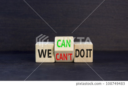 We can do it symbol. Concept word We can or can not do it on beautiful wooden cubes. Beautiful black table black background. Business and we can or not do it concept. Copy space. 108749483