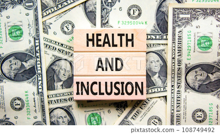 Health and inclusion symbol. Concept words Health and inclusion on wooden block. Dollar bills. Beautiful background from dollar bills. Business motivational health and inclusion concept. Copy space. 108749492