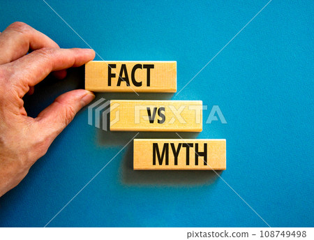 Fact vs myth symbol. Concept words Fact vs myth on wooden blocks on a beautiful blue table blue background. Businessman hand. Business, finacial and fact vs myth concept. Copy space. 108749498
