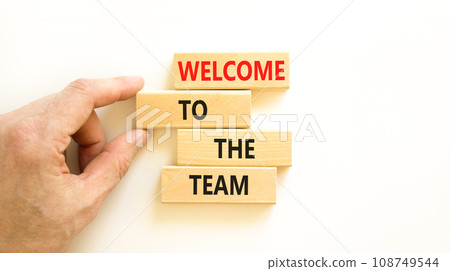 Welcome to the team symbol. Concept words Welcome to the team on wooden block. Beautiful white table white background. Businessman hand. Business, motivational and welcome to the team concept. Welcome to the team symbol. Concept words Welcome to the team on wooden block. Beautiful white table white background. Businessman hand. Business, motivational and welcome to the team concept. 108749544
