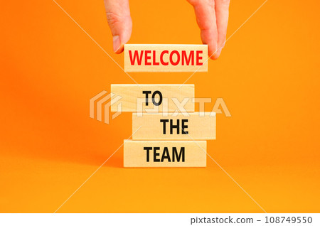 Welcome to the team symbol. Concept words Welcome to the team on wooden block. Beautiful orange table orange background. Businessman hand. Business, motivational and welcome to the team concept. Welcome to the team symbol. Concept words Welcome to the team on wooden block. Beautiful orange table orange background. Businessman hand. Business, motivational and welcome to the team concept. 108749550