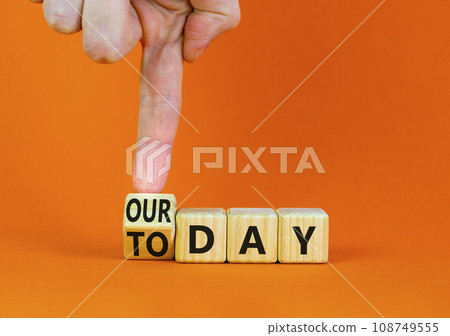 Today is our day symbol. Businessman turns the wooden cube and changes concept words Today to our day. Beautiful orange background, copy space. Business, motivation today is our day concept. Today is our day symbol. Businessman turns the wooden cube and changes concept words Today to our day. Beautiful orange background, copy space. Business, motivation today is our day concept. 108749555