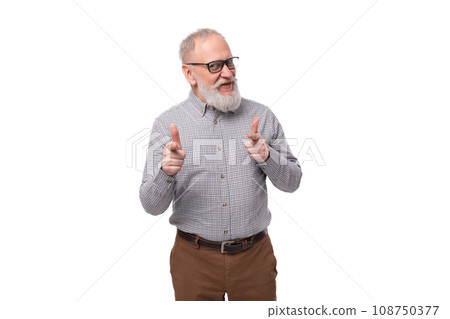 a handsome old man with a mustache and a beard in glasses is dressed in a shirt and trousers on a a handsome old man with a mustache and a beard in glasses is dressed in a shirt and trousers on a 108750377