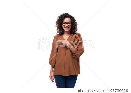 portrait of a cheerful young caucasian curly brunette woman dressed in a beautiful brown shirt 108750618