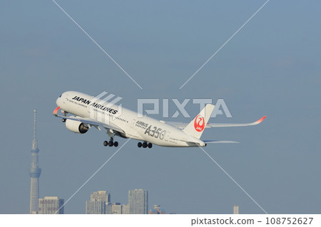 A350 passenger plane takes off and climbs with the Sky Tree in the background A350 passenger plane takes off and climbs with the Sky Tree in the background 108752627
