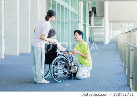 Senior woman in wheelchair and nursing staff 108752751