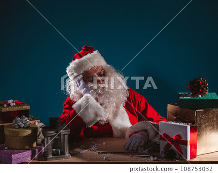 Tired santa claus is sleeping due to christmas overwork Tired santa claus is sleeping due to christmas overwork 108753032