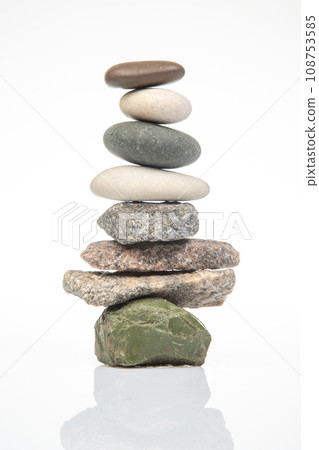 pyramid of stacked stones on a white background. stabilization and balance in life 108753585