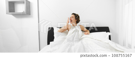Image of smiling, beautiful modern woman wake up in her bed, yawning with pleased face, had a good night sleep Image of smiling, beautiful modern woman wake up in her bed, yawning with pleased face, had a good night sleep 108755167