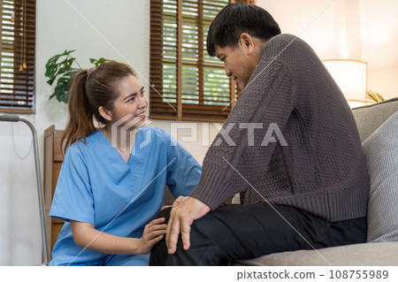 physiotherapist doctor or caregiver helping senior elderly man stretching his hamstring 108755989