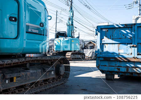 Heavy machinery lined up at the demolition site, cool colors Heavy machinery lined up at the demolition site, cool colors 108756225