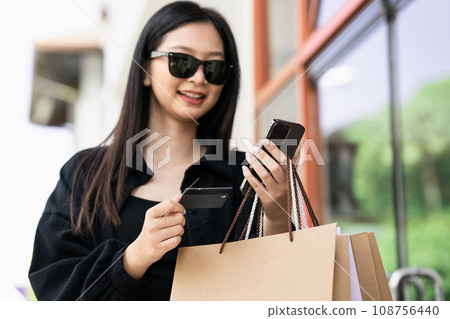 Shopping, credit card and phone for woman with ecommerce, information and confirmation. Online payment Shopping, credit card and phone for woman with ecommerce, information and confirmation. Online payment 108756440