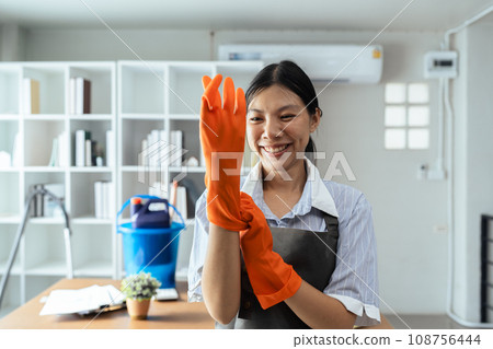 Female housekeeper smile and wearing glove, preparing to clean office 108756444
