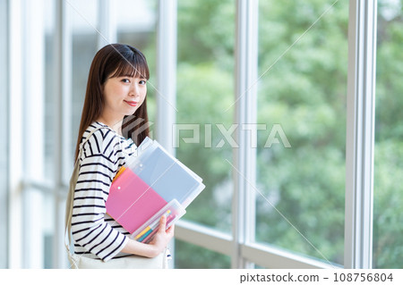 A female university student standing in the hallway. Photography cooperation: Ariake College of Education and Arts A female university student standing in the hallway. Photography cooperation: Ariake College of Education and Arts 108756804