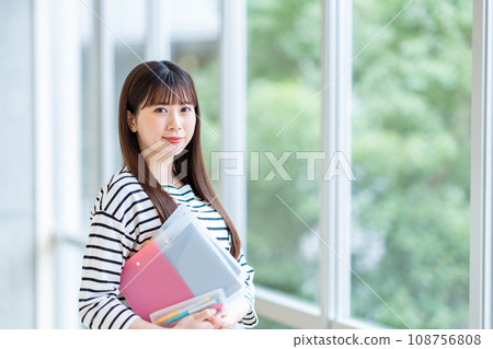 A female university student standing in the hallway. Photography cooperation: Ariake College of Education and Arts A female university student standing in the hallway. Photography cooperation: Ariake College of Education and Arts 108756808